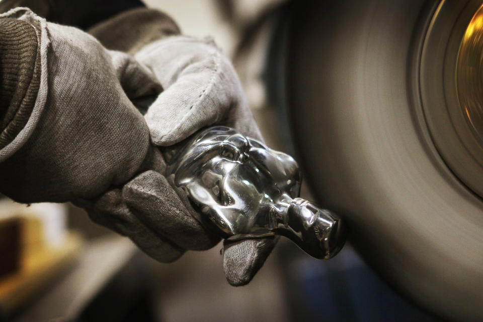 CHICAGO, IL - FEBRUARY 09: A worker polishes an Oscar statuette at R.S. Owens & Company February 9, 2012 in Chicago, Illinois. R.S. Owens manufactures the Oscar statuettes which are presented at the annual Academy Awards by the Academy of Motion Picture Arts and Sciences. After the theft of the statuettes prior to the 2000 Academy Awards the company began casting the statuettes one year in advance of the show. (Photo by Scott Olson/Getty Images)