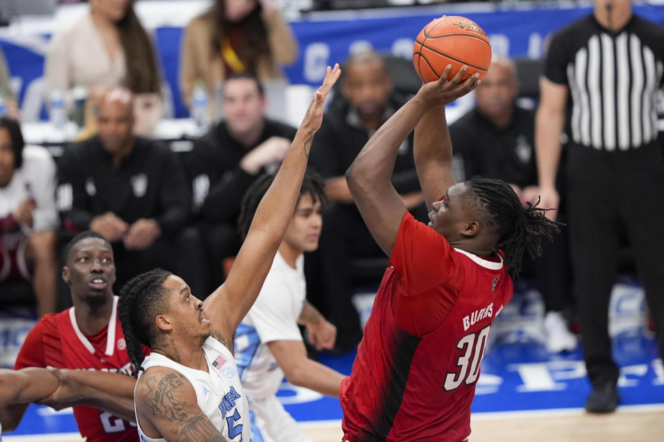 North Carolina State forward DJ Burns Jr. (30) shooting against North Carolina forward Armando Bacot (5) during the second half of an NCAA college basketball game in the championship of the Atlantic Coast Conference tournament, Saturday, March 16, 2024, in Washington. (AP Photo/Susan Walsh)