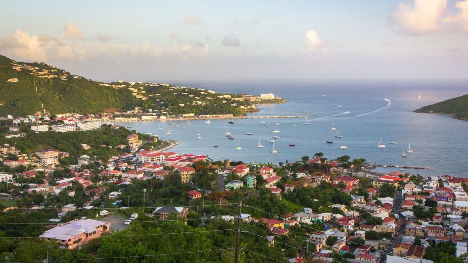 The sun begins to lower in the sky on a partly cloudy day overlooking the port of Charlotte Amalie, St Thomas, USVI