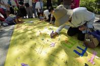 <p>People write down peace messages at Hiroshima Peace Memorial Park on Aug. 6, 2017 in Hiroshima, Japan. (Photo: David Mareuil/Anadolu Agency/Getty Images) </p>