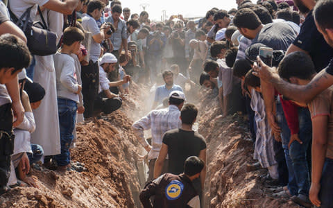 The murdered White Helmets were buried on Saturday in Idlib - Credit: OMAR HAJ KADOUR/AFP/Getty Images