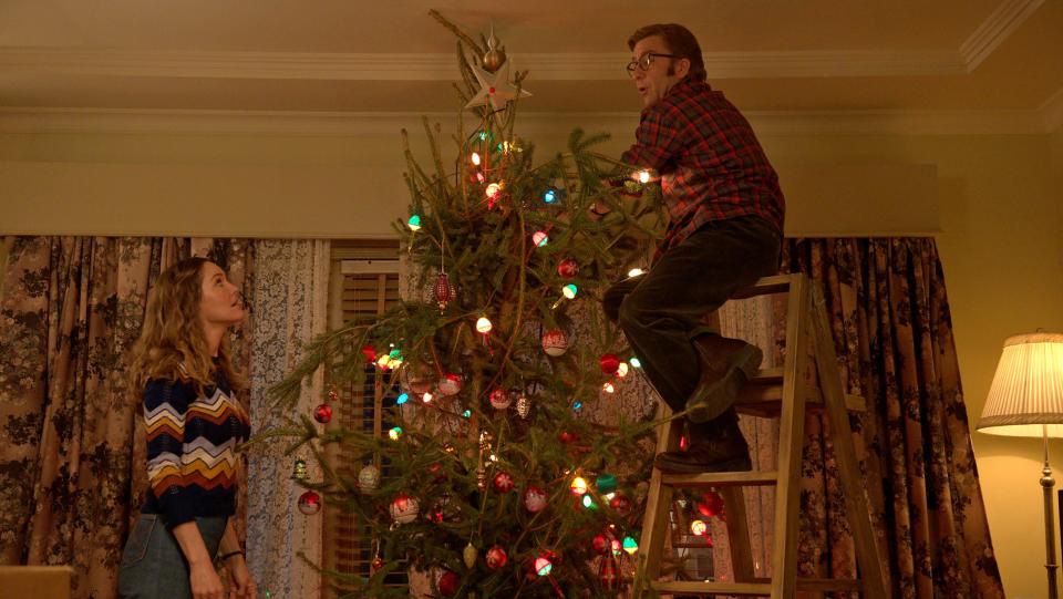 Ralphie (Peter Billingsley) and his wife Sandy (Erinn Hayes) trim an oversized tree in the 1970s-set sequel "A Christmas Story Christmas."