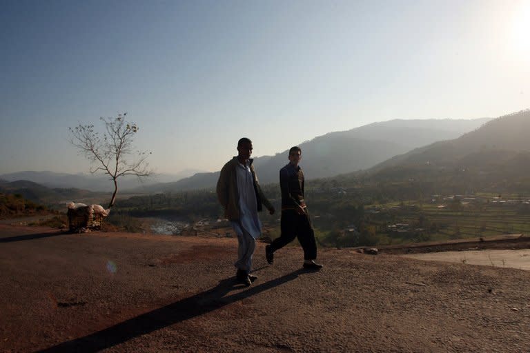 Pakistani Kashmiris walk on a road leading towards the town of Titrinot, some 30 kilometers north of Battal sector and close to the Pakistan-India border, on January 10, 2013. Pakistan said one of its soldiers was killed Thursday by "unprovoked" Indian firing across their tense border in Kashmir, the third deadly incident reported in five days in the disputed region