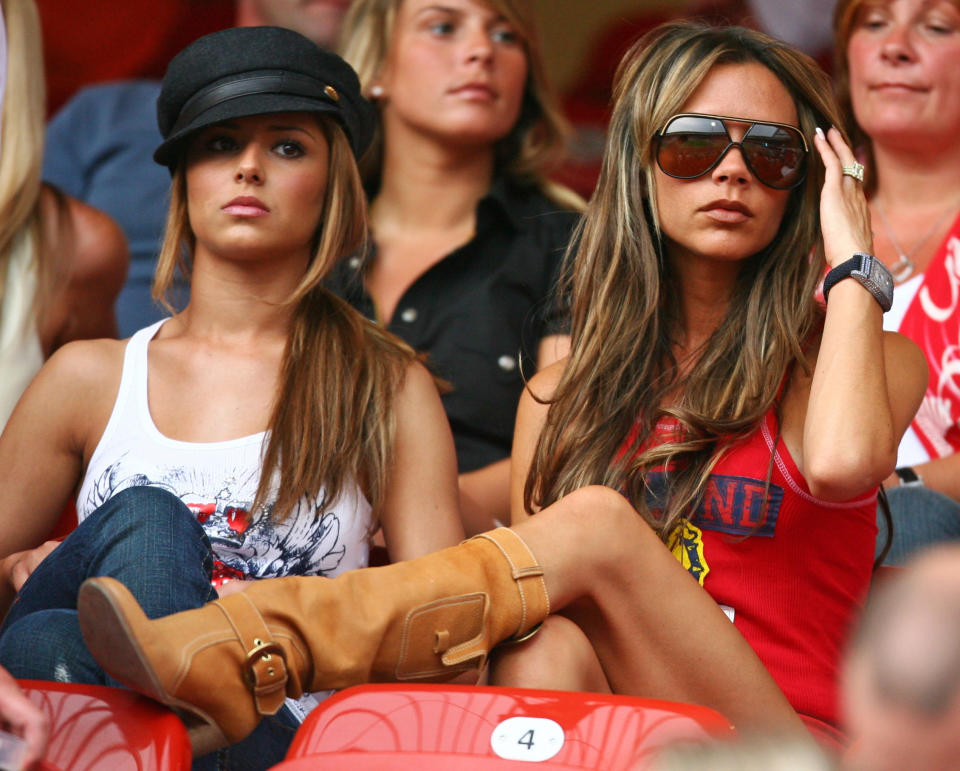 Cheryl Tweedy (L), girlfriend of England&#39;s Ashley Cole, sits in the stands with Victoria Beckham (R), wife of England&#39;s David Beckham, and Coleen McLoughlin (C Top), girlfriend of England&#39;s Wayne Rooney, before Trinidad and Tobago&#39;s Group B World Cup 2006 soccer match against England in Nuremberg June 15, 2006.  FIFA RESTRICTION - NO MOBILE USE     REUTERS/Kai Pfaffenbach     (GERMANY)