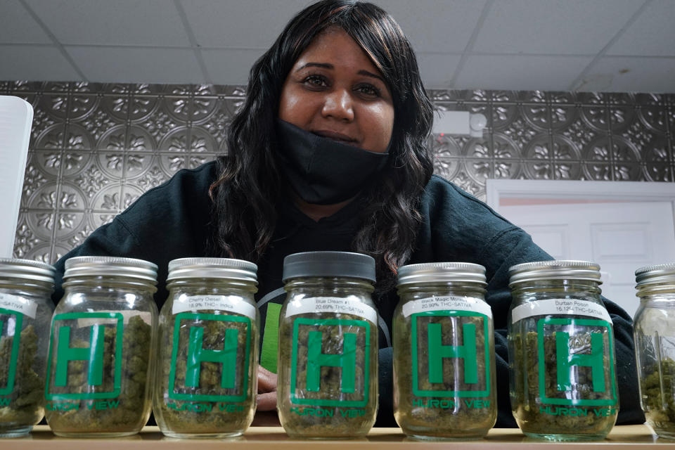 Teesha Montague shows off the wares at Huron View Provisioning in Ann Arbor, Michigan, earlier this year. - Credit: Paul Sancya/AP