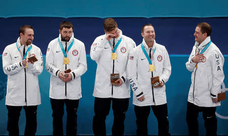 Curling - Pyeongchang 2018 Winter Olympics - Men's Final - Sweden v U.S. - Gangneung Curling Center - Gangneung, South Korea - February 24, 2018 - Gold medallists alternate Joe Polo of the U.S., lead John Landsteiner of the U.S, second Matt Hamilton of the U.S, vice-skip Tyler George of the U.S, and skip John Shuster of the U.S react on the podium during the victory ceremony. REUTERS/Cathal McNaughton