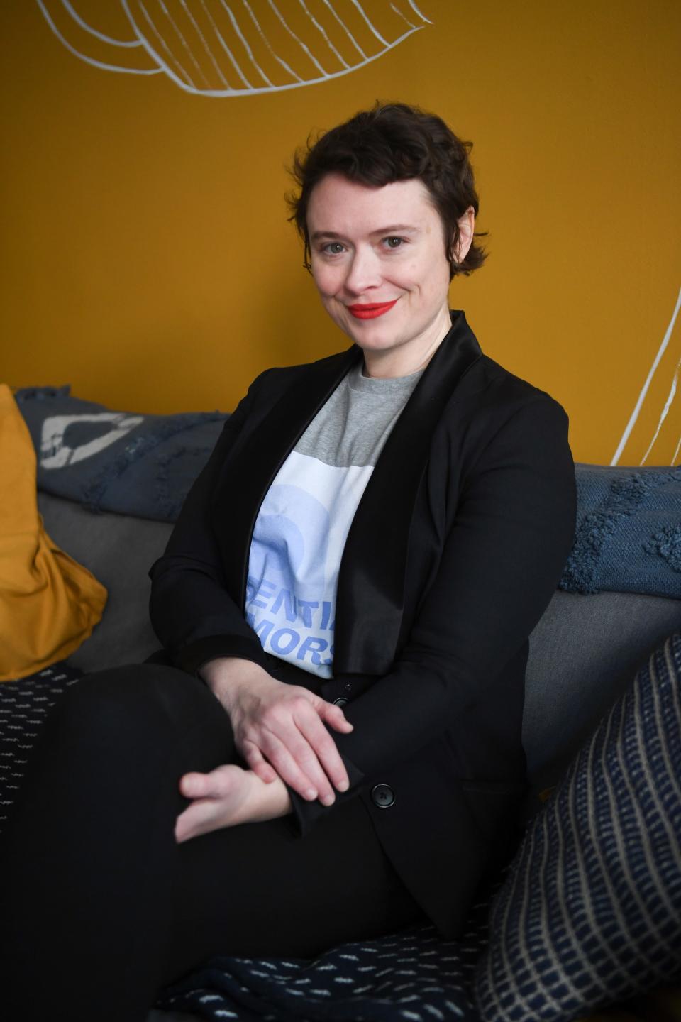 Amanda Mohney of The Pigeon Parade Quarterly sits on her couch in downtown Knoxville, Saturday, Feb. 5, 2022.