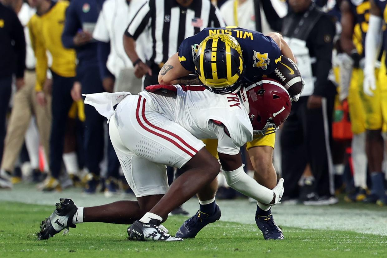 Alabama Crimson Tide defensive back Kool-Aid McKinstry (1) tackles Michigan Wolverines wide receiver Roman Wilson (1) in the fourth quarter in the 2024 Rose Bowl college football playoff semifinal game at Rose Bowl.