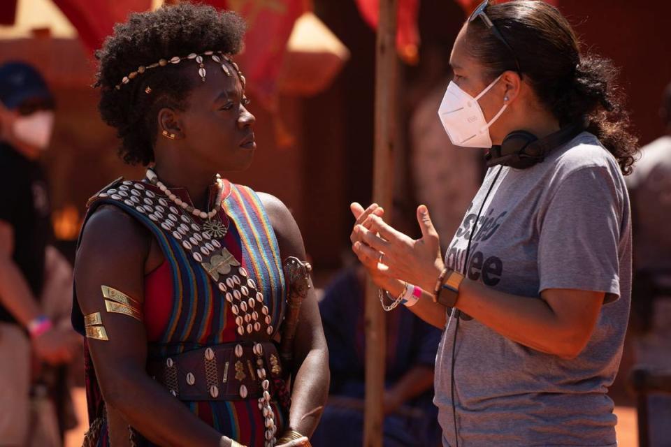 Viola Davis, left, works with director Gina Prince-Bythewood on the set of “The Woman King.”