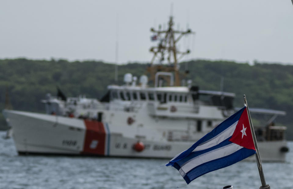 FILE - In this June 29, 2021 file photo, a Cuban flag from a Cuban Border Patrol boat flies as the Coast Guard Sentinel-class cutter Charles Sexton arrives to deliver Cuban deportees to the authorities at Orozco Bay in Artemisa, Cuba. Cuba is seeing a surge in unauthorized migration to the United States, fueled by an economic crisis. (AP Photo/Ramon Espinosa, File)