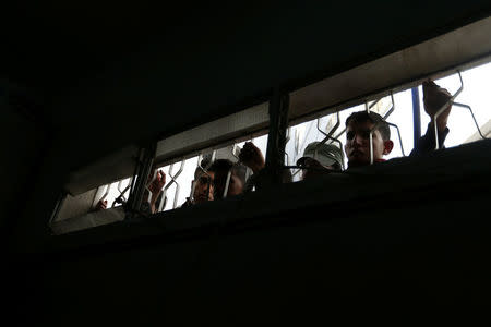 Palestinians look at dead bodies at a hospital following an explosion in the southern Gaza Strip, April 14, 2018. REUTERS/Ibraheem Abu Mustafa