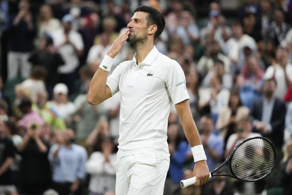 Novak Djokovic of Serbia celebrates after defeating Holger Rune of Denmark in their fourth round match at the Wimbledon tennis championships in London, Monday, July 8, 2024. (AP Photo/Kirsty Wigglesworth)
