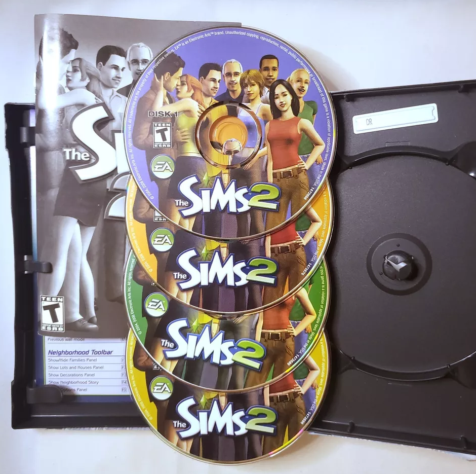 "The Sims 2" video game CDs and case with characters displayed on the cover and discs