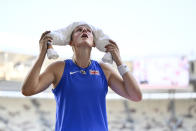 FILE - Holly Bradshaw, of Great Britain, keeps an ice packed towel on her head to keep cool as she wait to compete in the Women's pole vault qualification during the World Athletics Championships in Budapest, Hungary, Monday, Aug. 21, 2023. (AP Photo/Denes Erdos, File)