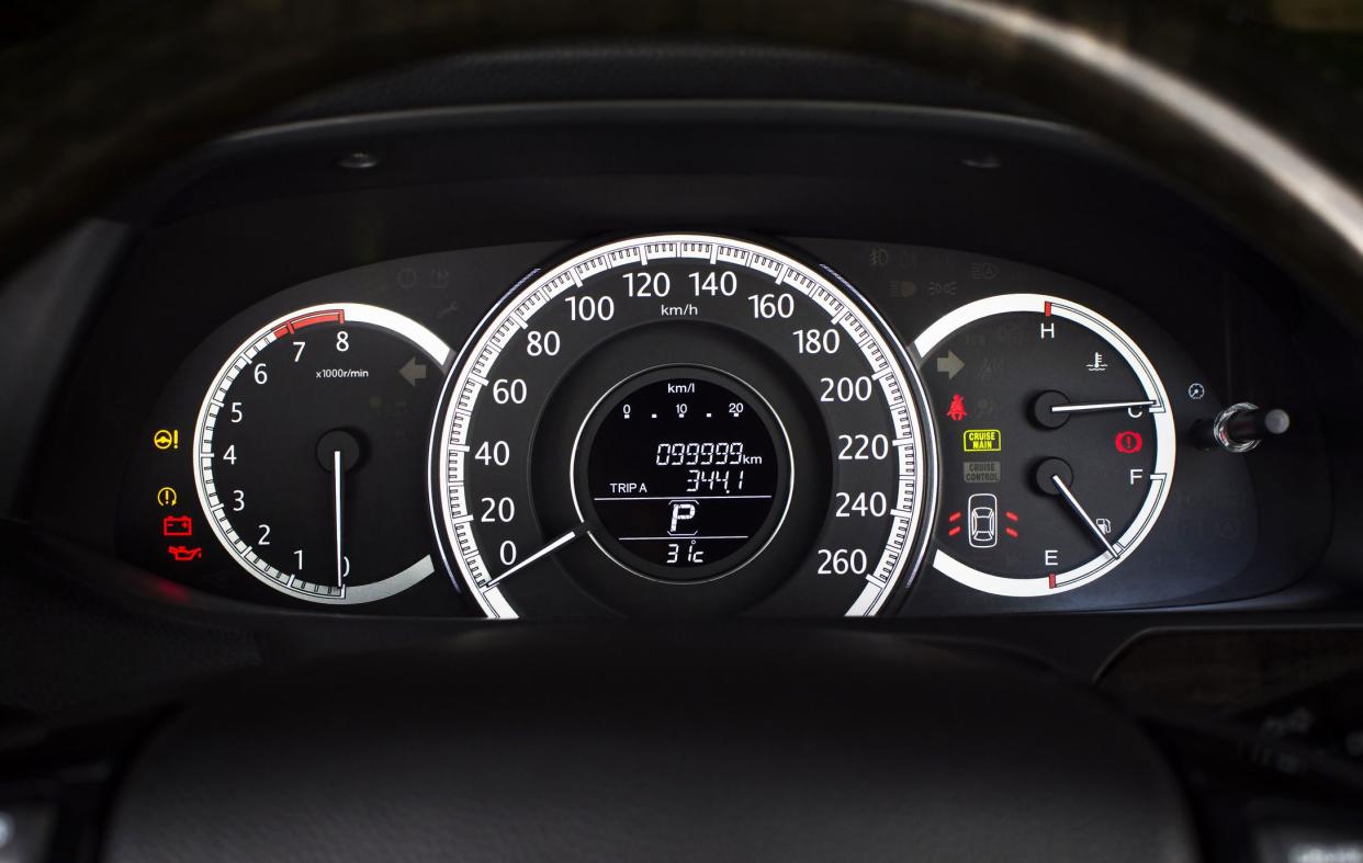 Car speedometer with kilometer per hour and tachometer,fuel meter,odometer and warning light on a car dashboard.