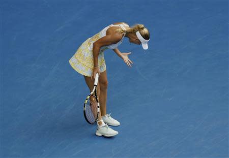 Caroline Wozniacki of Denmark reacts during her women's singles match against Garbine Muguruza of Spain at the Australian Open 2014 tennis tournament in Melbourne January 18, 2014. REUTERS/Brandon Malone