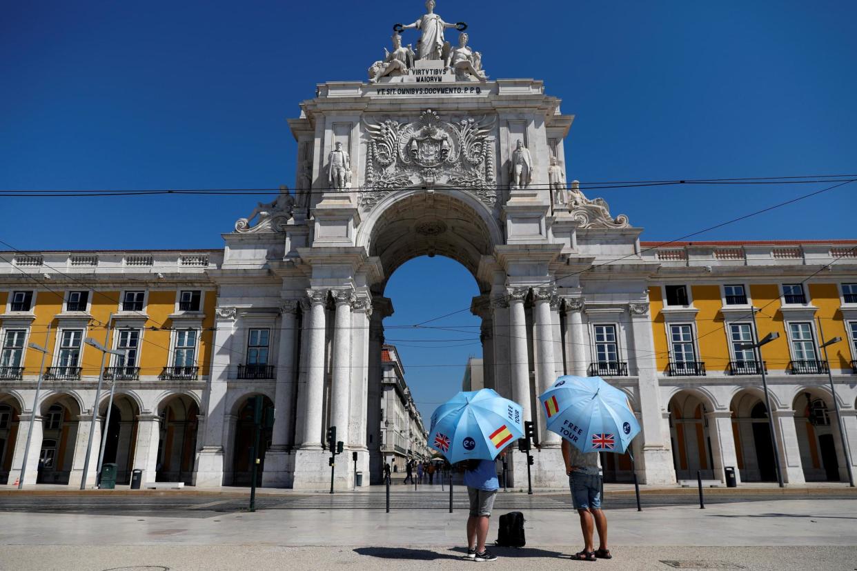 Tourist guides wait for customers at Comercio square in Lisbon, Portugal: REUTERS