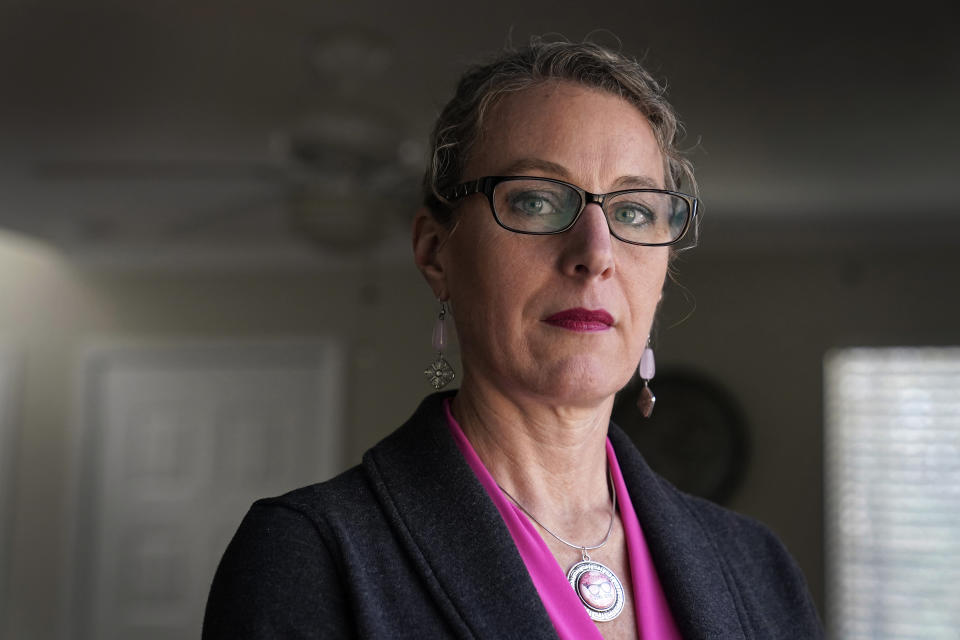 Susanna Schmitt Williams poses at her home in Chapel Hill, N.C., Thursday, Feb. 25, 2021. Williams, the former chief of the Carrboro Fire Department, considered suicide after enduring harassment in her department despite becoming chief. Advocates for female firefighters say their struggles are part of a larger trend, as evidenced by recent gender discrimination lawsuits against fire departments in Illinois, Virginia, and Texas. (AP Photo/Gerry Broome)