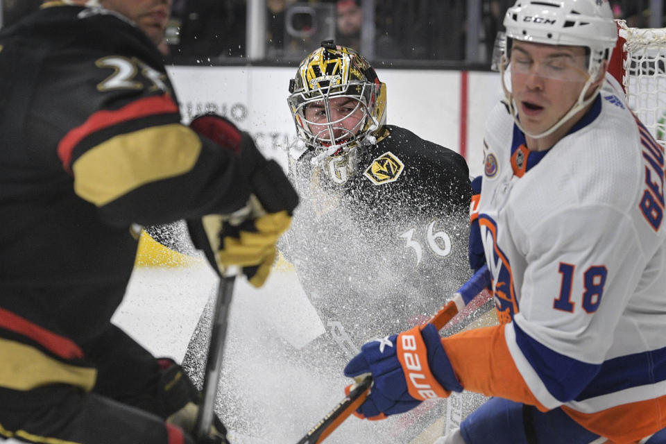 Vegas Golden Knights goaltender Logan Thompson (36) is seen through a spray of ice during the third period of an NHL hockey game against the New York Islanders Saturday, Dec. 17, 2022, in Las Vegas. The Islanders defeated the Golden Knights 5-2. (AP Photo/Sam Morris)