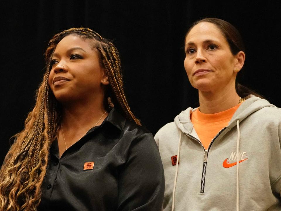 Sue Bird (right) stands alongside Cherelle Griner during a press conference.