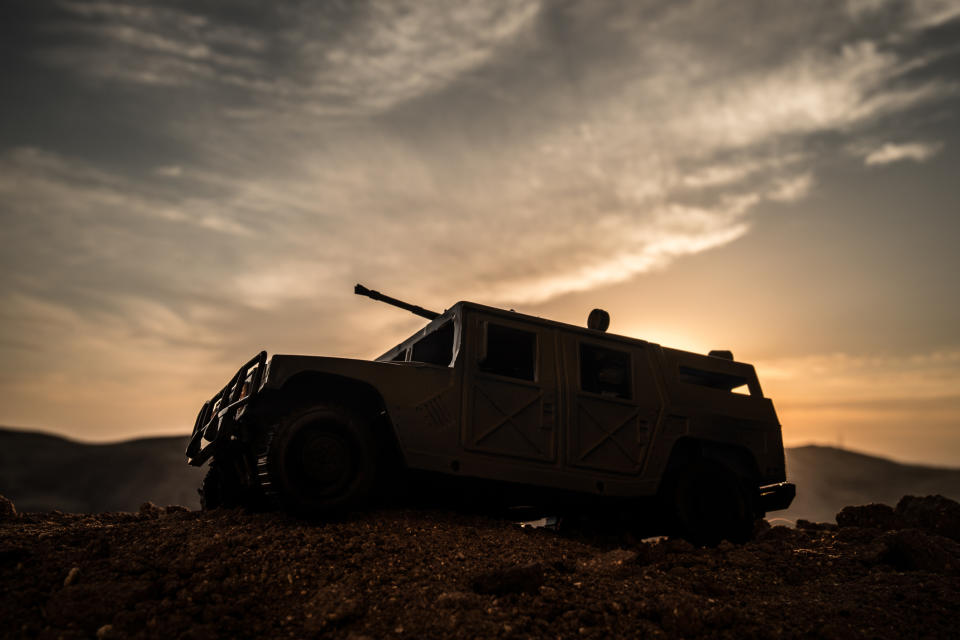 Military patrol car with sunset in the background.