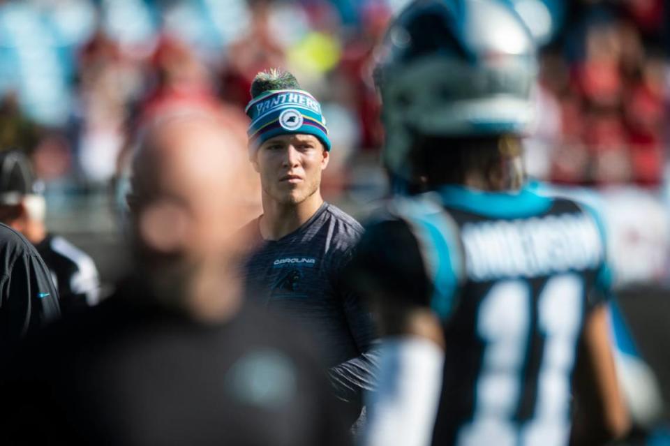 Panthers running back Christian McCaffrey watches team warm-ups before the game against the Buccaneers at Bank of America Stadium on Sunday, December 26, 2021 in Charlotte, NC.