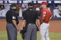 Philadelphia Phillies manager Joe Girardi (25) argues a call with umpires Hunter Wendelstedt (21) and Stu Scheurwater during the first inning of the second game of a baseball doubleheader against the Miami Marlins, Sunday, Sept. 13, 2020, in Miami. (AP Photo/Wilfredo Lee)