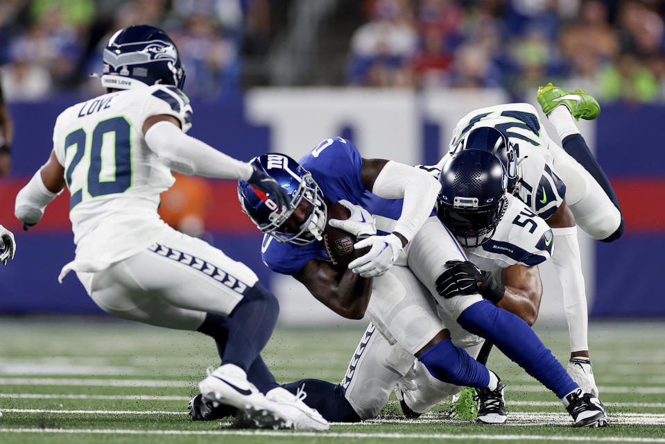 New York Giants wide receiver Parris Campbell (0) is tackled by Seattle Seahawks linebacker Bobby Wagner (54) during the second quarter of an NFL football game, Monday, Oct. 2, 2023, in East Rutherford, N.J. (AP Photo/Adam Hunger)