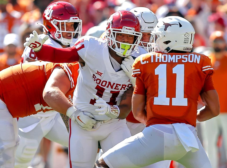 Oklahoma's Jadon Haselwood (11) tries to get to Texas's Casey Thompson (11) during the Red River Showdown college football game between the University of Oklahoma Sooners (OU) and the University of Texas (UT) Longhorns at the Cotton Bowl in Dallas, Saturday, Oct. 9, 2021. Oklahoma won 55-48.