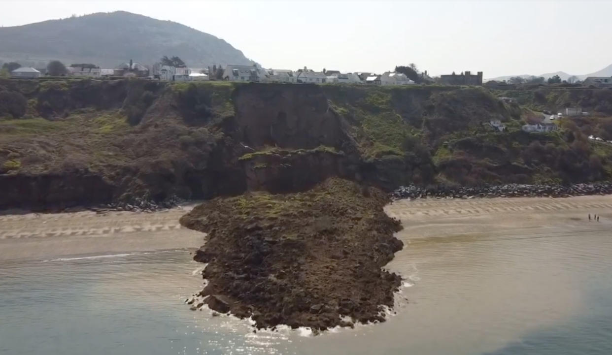 A giant landslide slid onto a beach today - only minutes after people had walked on the sand.

Large parts of clifftop gardens - and even a wooden bench - were carried onto the beach in the fall.
 
Police were urging people to stay away from the landslide at Nefyn near Pwllheli, North Wales, in case of more falls.

Hairdress Christian Pilling said: 