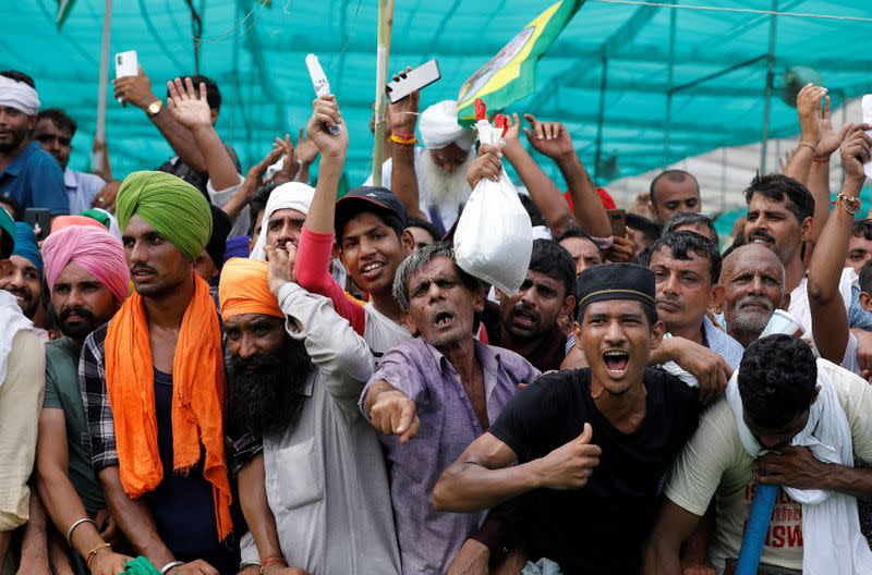 People shout slogans during a Maha Panchayat or grand village council meeting as part of a farmers' protest against farm laws in Muzaffarnagar