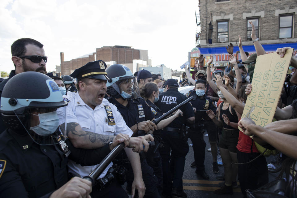 Protesters face off with police officers 