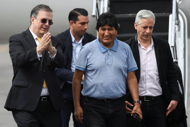 Bolivia's ousted President Evo Morales is welcomed by Mexico's Foreign Minister Marcelo Ebrard during his arrival to take asylum in Mexico, in Mexico City