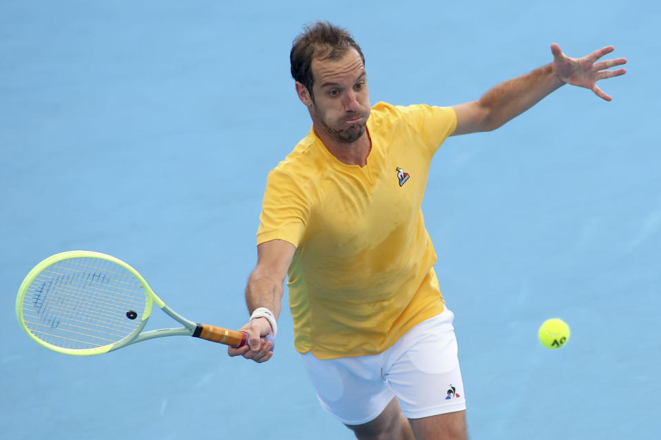 Richard Gasquet of France makes a forehand return to Marcos Giron of the United States during their Round of 32 match at the Adelaide International tennis tournament in Adelaide, Australia, Sunday, Jan. 1, 2023. (AP Photo/Kelly Barnes)