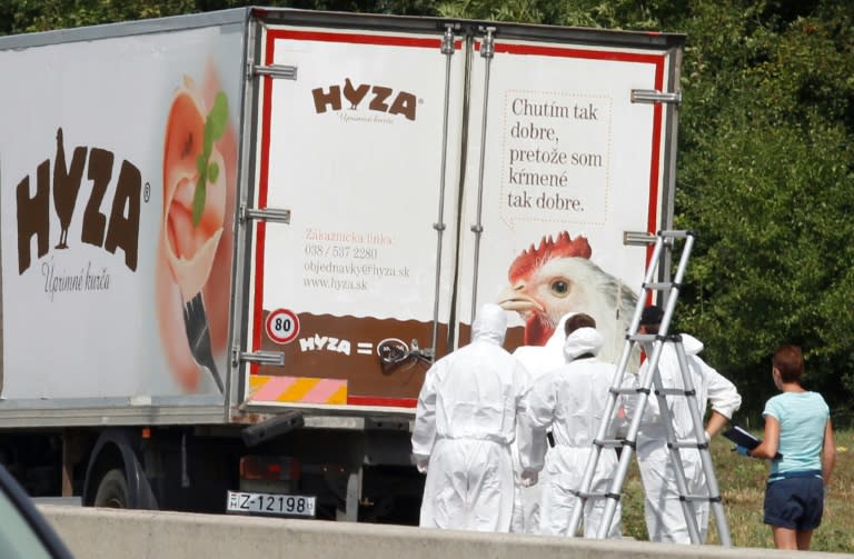 In this file photo taken on August 27, 2015 forensic investigators work on a refrigerated truck parked along a highway near Neusiedl am See, Austria, after the bodies of 71 migrants where found suffocated in the lorry. The four main suspects involved in the gruesome deaths of 71 migrants in a truck on in 2015 were sentenced to 25 years in jail on June 14, 2018, in a case that sparked international revulsion. The trial took place in Kecskemét, Hungary, which took over the proceedings from Vienna after it emerged that the migrants had suffocated in Hungary