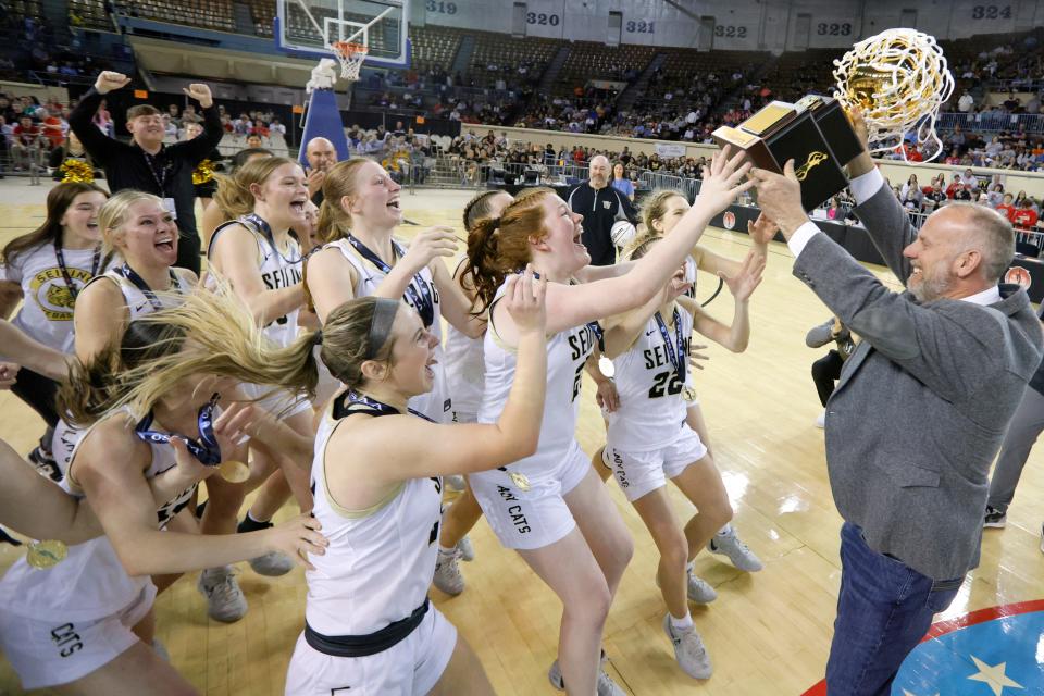 Seiling players run to get their trophy after beating Oklahoma Bible Academy for the Class A girls state basketball championship Saturday at State Fair Arena.