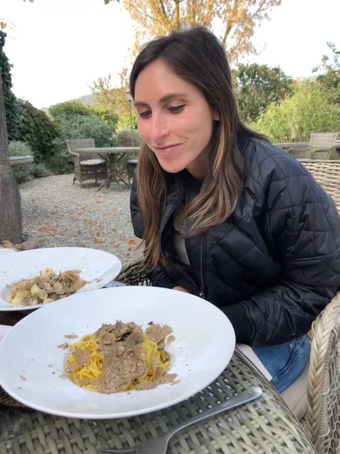 A woman with two large bowls of pasta