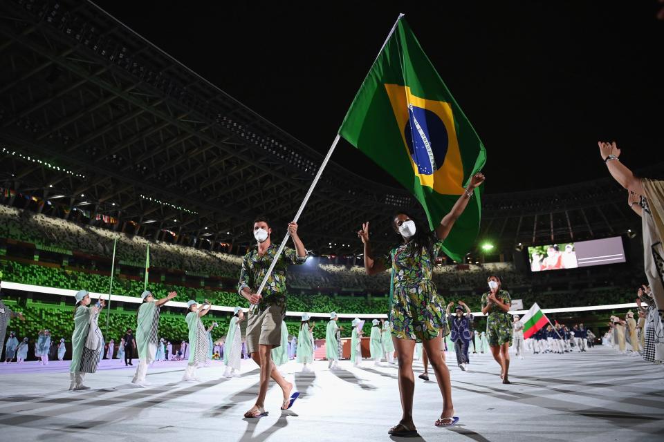 Flag bearers Ketleyn Quadros and Bruno Mossa Rezende of Team Brazil lead their team out during the opening ceremony.