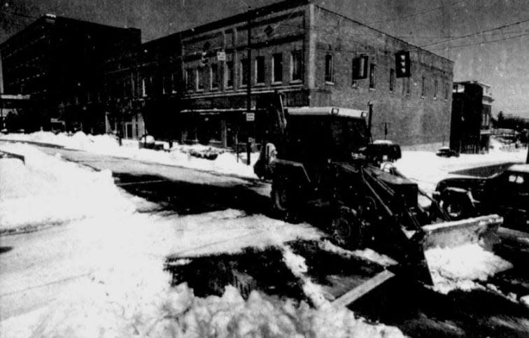 A tractor clears the road on Main Street in Hendersonville on March 14, 1993.