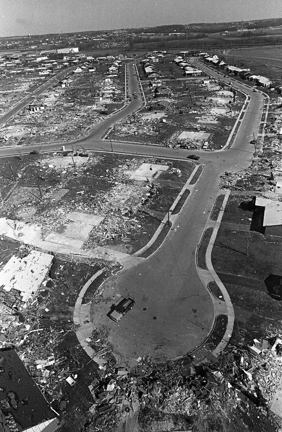 FILE - Xenia, Ohio, appears in this aerial photo of April 18, 1974, following the tornado of April 3. The section is known as the Arrowhead area of Xenia: where the tornado first touched down. The deadly tornado killed 32 people, injured hundreds and leveled half the city of 25,000. Nearby Wilberforce was also hit hard. As the Watergate scandal unfolded in Washington, President Richard Nixon made an unannounced visit to Xenia to tour the damage. Xenia's was the deadliest and most powerful tornado of the 1974 Super Outbreak. (AP Photo/Steve Pyle)