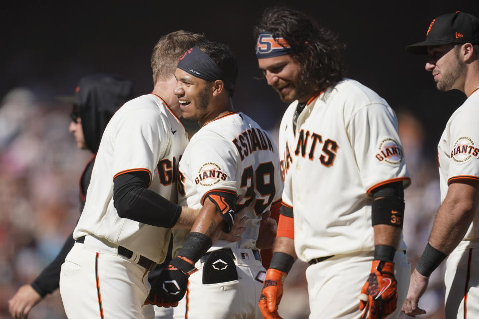 San Francisco Giants' Thairo Estrada, middle left, celebrates with teammates after hitting a two-run home run against the Pittsburgh Pirates during the ninth inning of a baseball game in San Francisco, Sunday, Aug. 14, 2022. (AP Photo/Jeff Chiu)