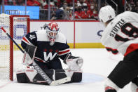 Washington Capitals goaltender Vitek Vanecek (41) stops a shot by Ottawa Senators left wing Tim Stützle (18) during the second period of an NHL hockey game, Saturday, Jan. 22, 2022, in Washington. (AP Photo/Nick Wass)