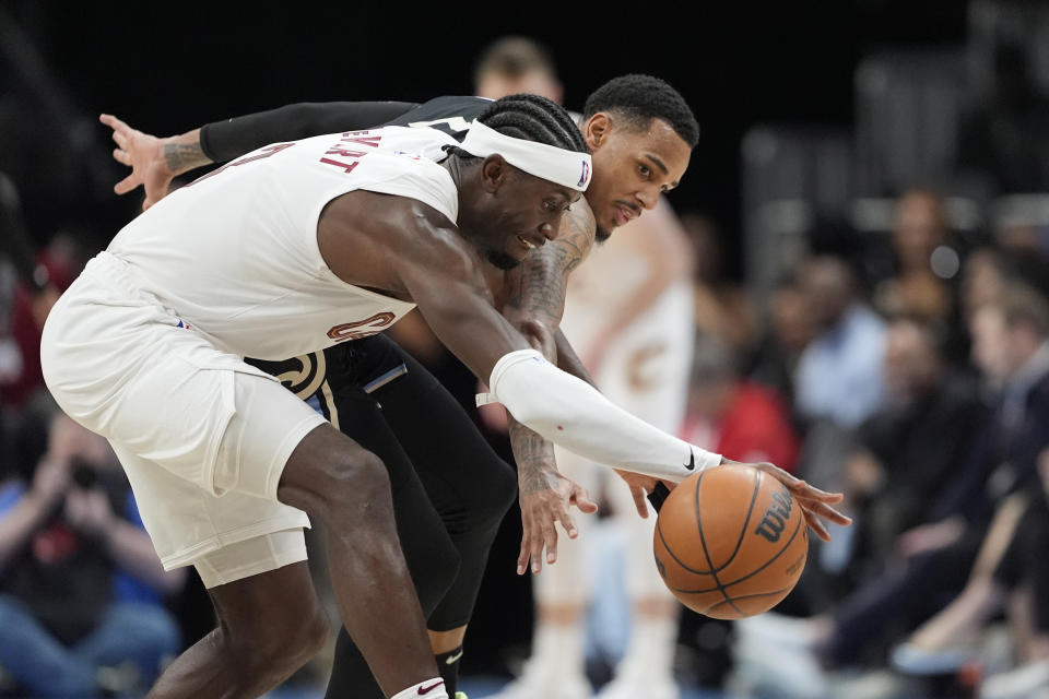 Cleveland Cavaliers guard Caris LeVert (3) and Atlanta Hawks guard Dejounte Murray (5) vie for the ball during the second half of an NBA basketball game Wednesday, March 6, 2024, in Atlanta. (AP Photo/John Bazemore)