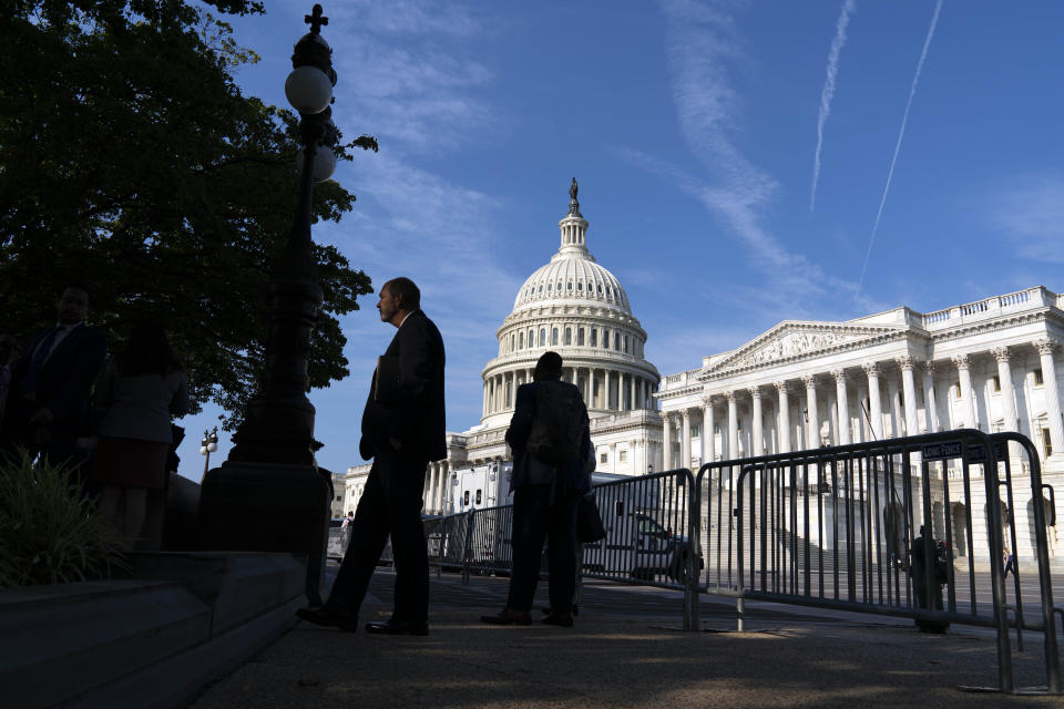 The U.S. Capitol is seen as people walking on the sidewalk with a fence, in Washington, Thursday, July 22, 2021. Speaker of the House Nancy Pelosi, D-Calif., discussed with reporters her reasons for rejecting two Republicans chosen by House GOP leader Kevin McCarthy to be on the committee investigating the Jan. 6 Capitol insurrection. (AP Photo/Jose Luis Magana)