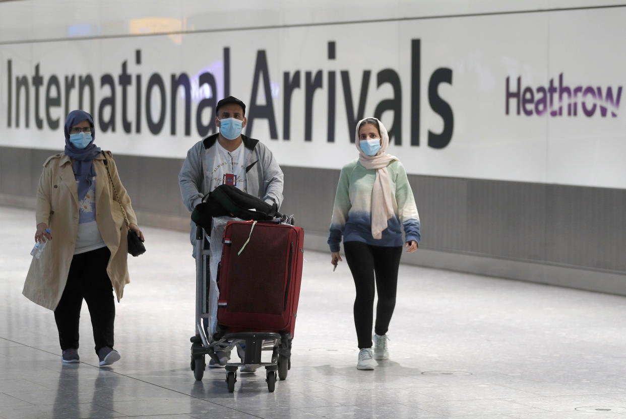 Passengers walk through the International arrivals area of Terminal 5 in London's Heathrow Airport, Britain, August 2, 2021.  REUTERS/Peter Nicholls
