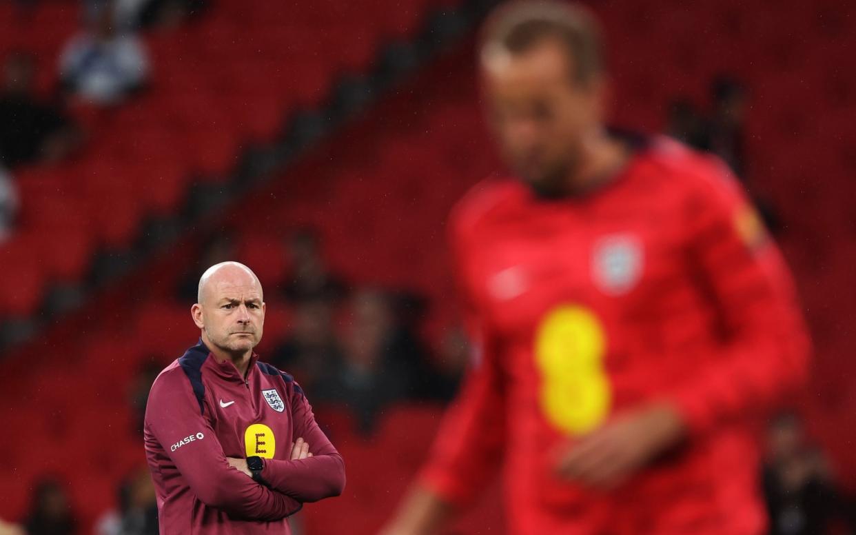 Lee Carsley, England's interim manager, looks on as Harry Kane warms up