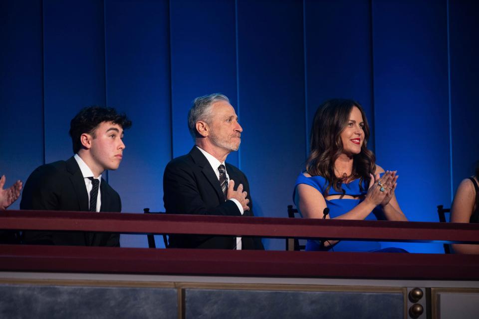 Mark Twain Prize recipient Jon Stewart is joined by his wife, Tracey Stewart, right, and son, Nate Stewart, left, after being introduced at the start of the 23rd annual Mark Twain Prize for American Humor at the Kennedy Center for the Performing Arts on April 24 in Washington.