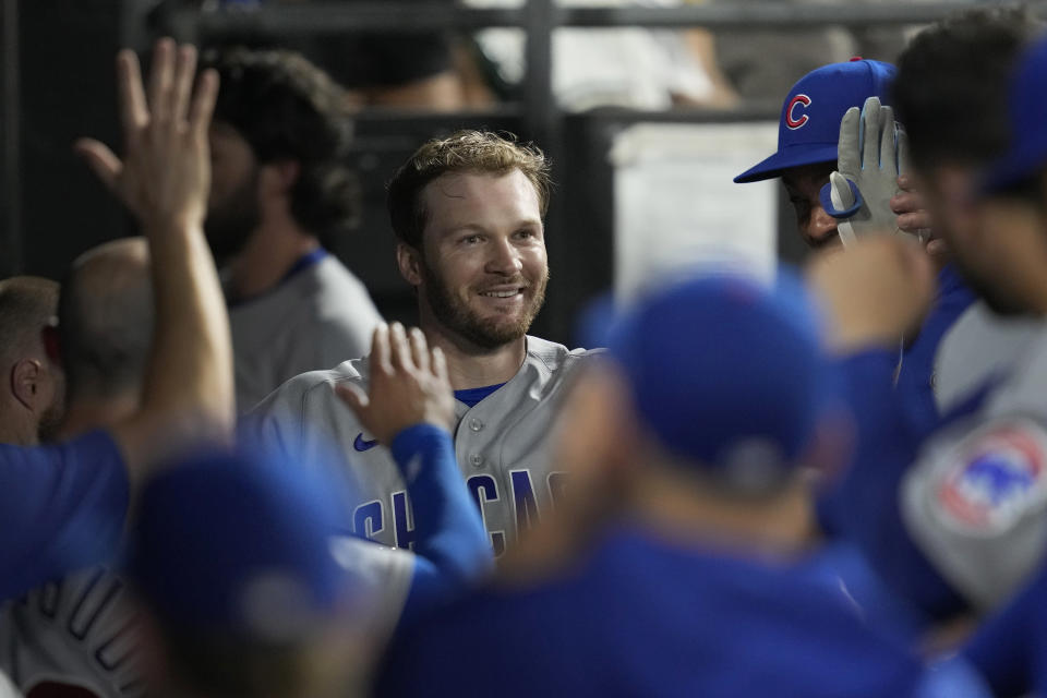 Chicago Cubs' Ian Happ smiles as he is congratulated in the dugout after his home run against the Chicago White Sox during the eighth inning of a baseball game Wednesday, July 26, 2023, in Chicago. (AP Photo/Charles Rex Arbogast)