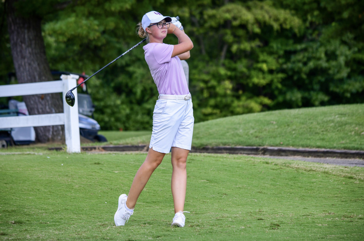 Kate Petrova hits a tee shot during a practice.