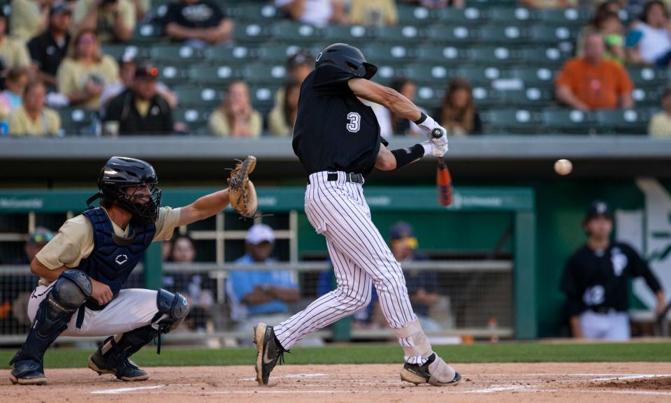 Cooper Hums hits the ball in the state championship baseball game between the Penn Kingsman and Cathedral Irish on Saturday, June 18, 2022 at Victory Field in Indianapolis. 